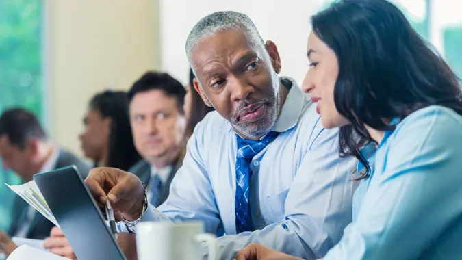 businessman talks with businesswoman at a professional seminar