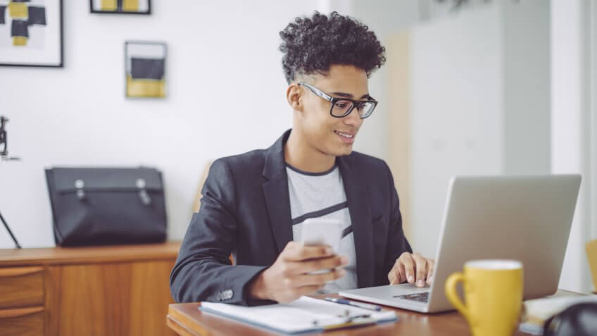 Young man working at home office.