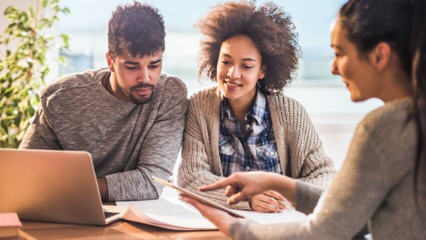 African American couple having a meeting with their real estate agent at home.