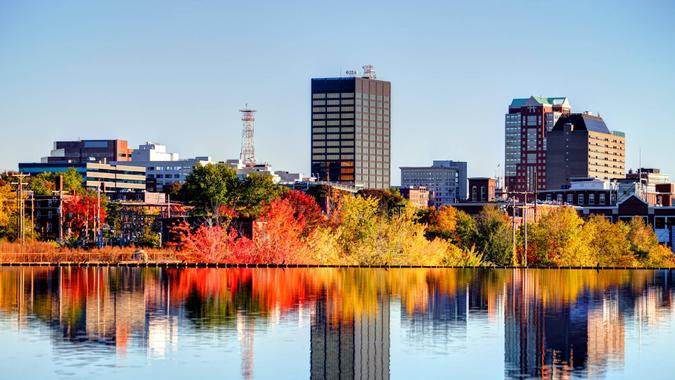 Manchester New Hampshire skyline along the banks of the Merrimack River in autumn.