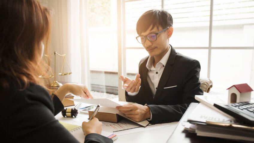 Consultation between attorney and employer about the tax laws for buying houses and residences in private areas to pay taxes economically to the government in accordance with the national law.