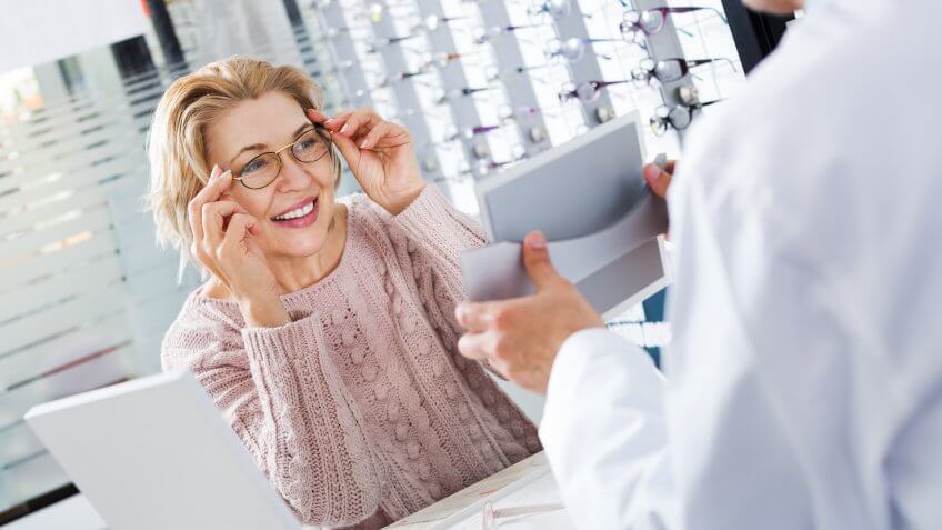 mature-ophthalmologist-female-pensioner-choosing-glasses