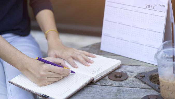 woman-hands-writing-plan-on-notebook