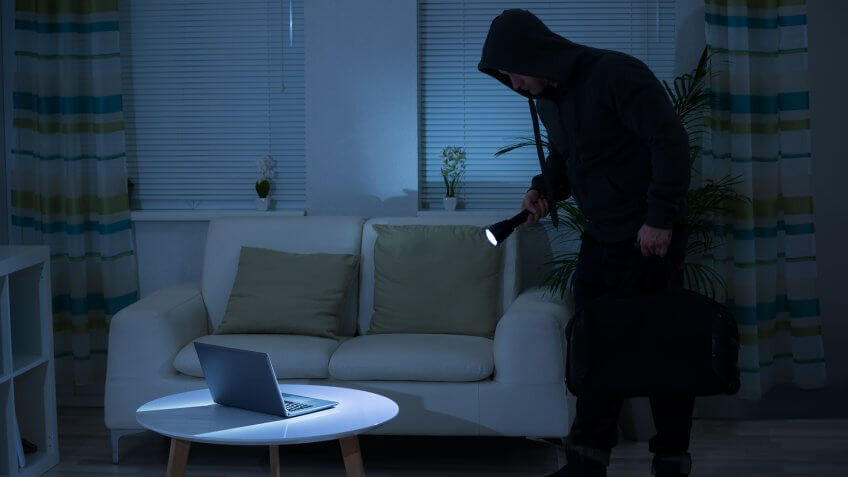 full-length-robber-holding-flashlight-over