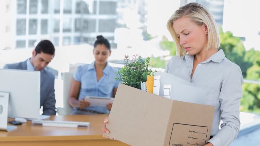 sad-businesswoman-leaving-office-after-being-laid-off