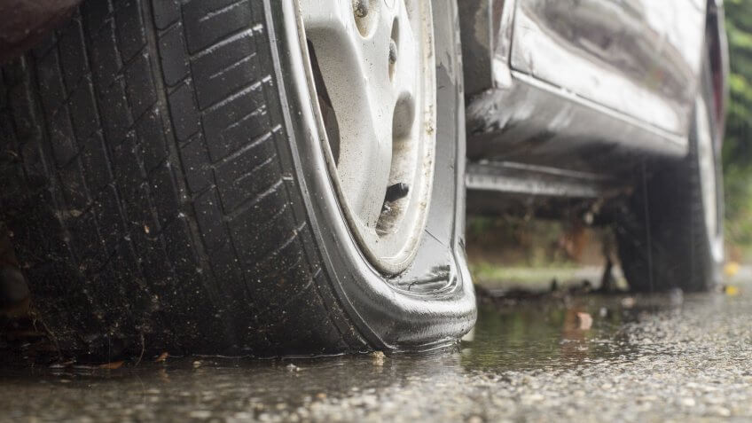 car-flat-tire-rainy-day