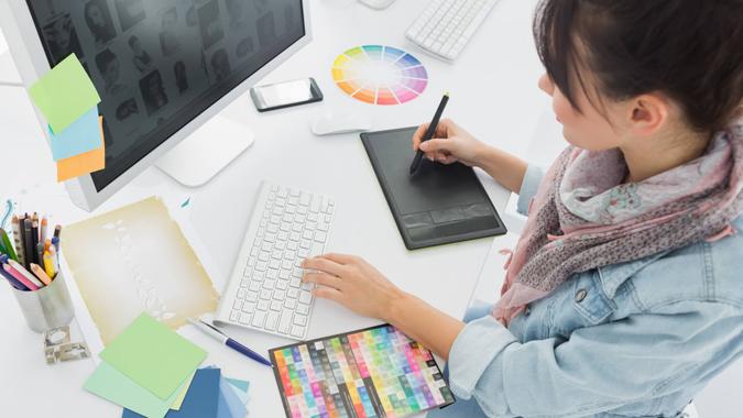 You Took a Pay Cut graphic designer working with a tablet
