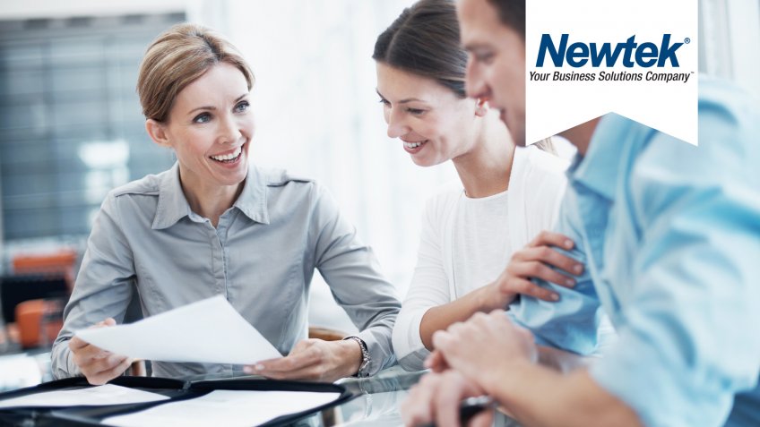 consultant explaining a document to a young couple