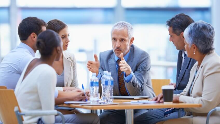 businessman sharing an idea with colleagues at a meeting