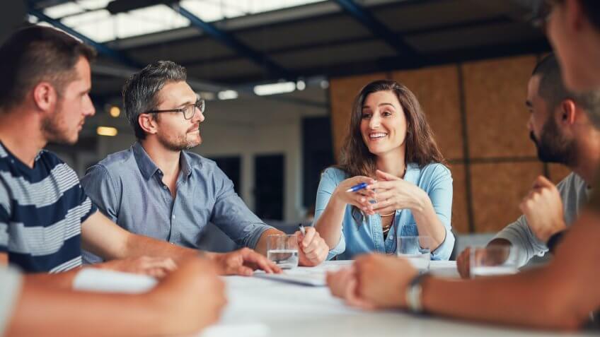 Shot of a group of coworkers having a meeting in an open plan office