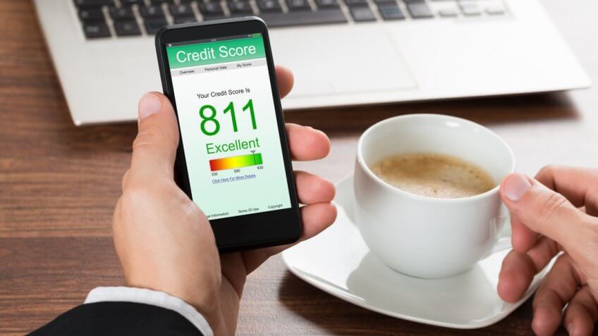 Close-up Of A Businessman Checking Credit Score Online On Cellphone While Having Coffee.
