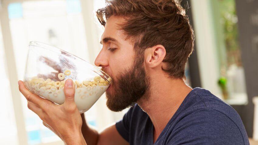 hungry-young-man-eating-breakfast-cereal