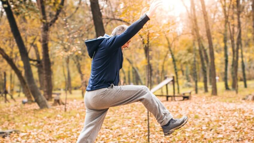 The photo of a senior man exercising.