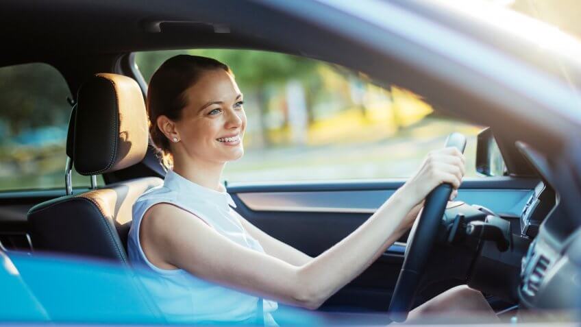 Close up photo of a businesswoman driving a car.