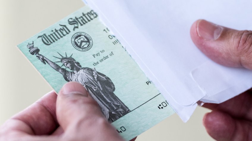Men hands holding a US Government Treasury check.