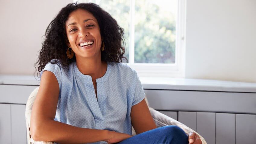 Portrait Of Woman Sitting In Chair At Home.
