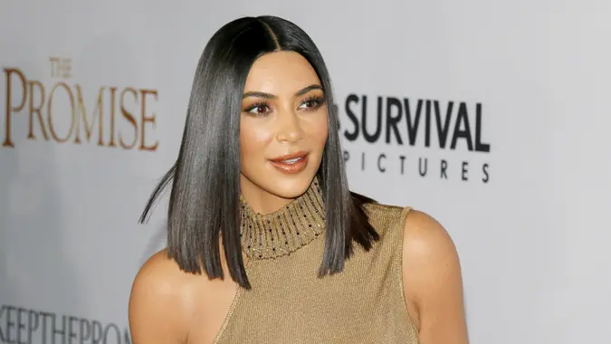 Kim Kardashian walking on a red carpet at an event