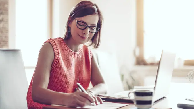 Woman, 30s, at home, businesswoman, working at home, home office, one person, small business, entrepreneur, smart phone, using phone, coffee, kitchen.