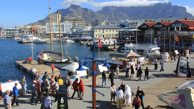 CAPE TOWN, SOUTH AFRICA - NOVEMBER 24, 2011 - Victoria and Alfred Waterfront, harbor with recreation boats, shops, restaurants and Table Mountain on background in Cape Town, South Africa.
