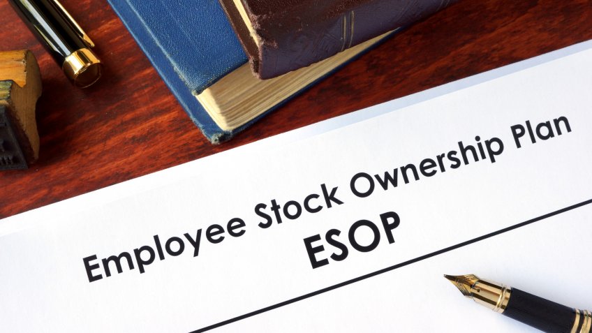 Papers with Employee Stock Ownership Plan (ESOP) on a table.