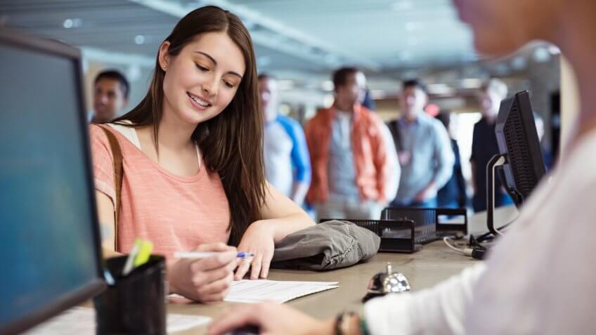 Young students registering for classes at college campus.