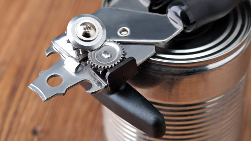 Tin opener opening a can.
