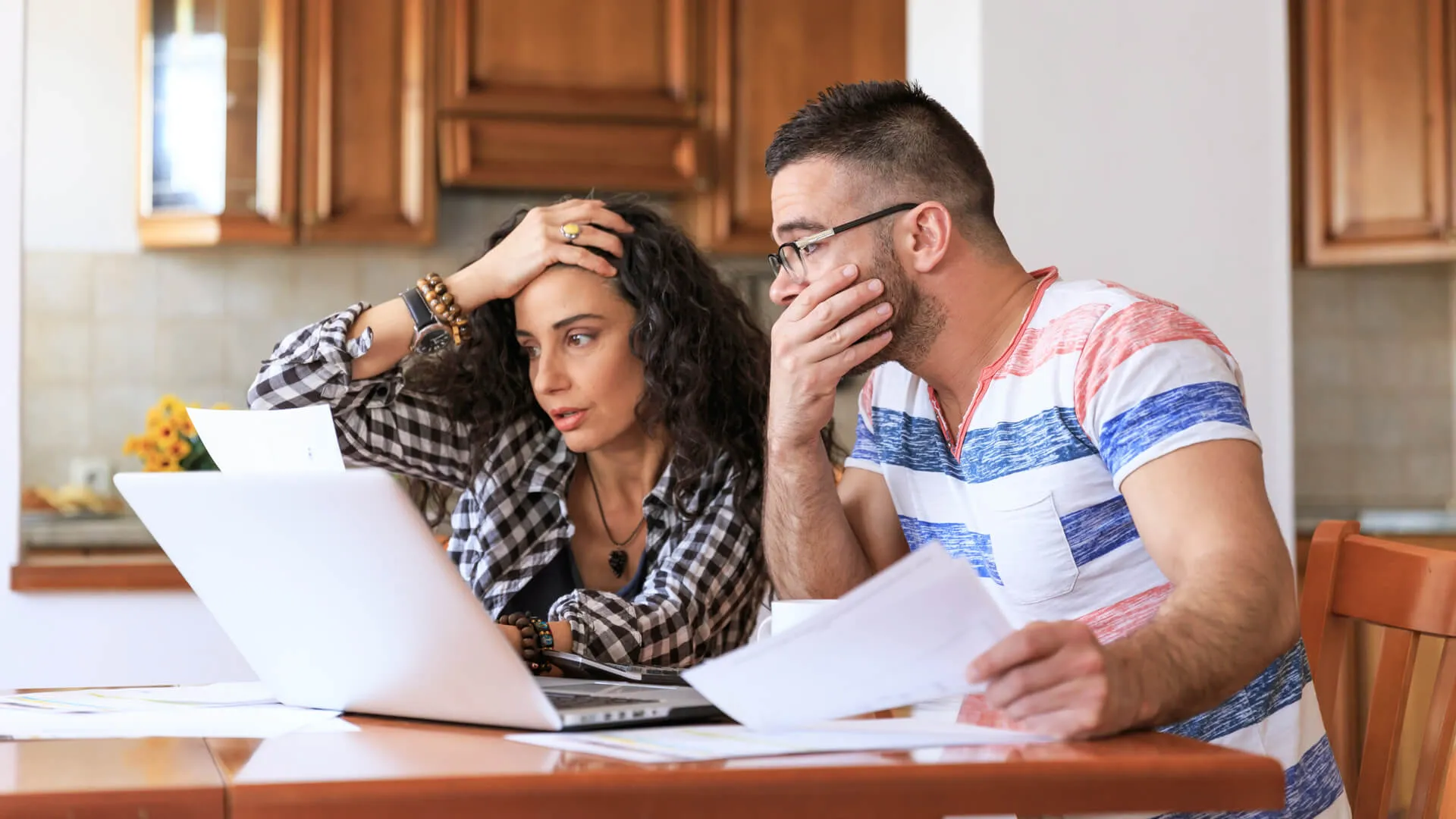 Young woman sitting at home and making home finances, with casual clothes.