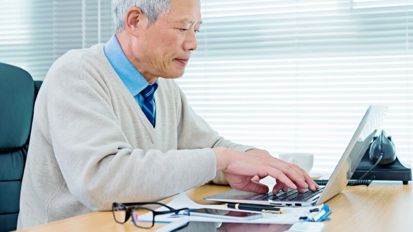 Senior businessman working in office.