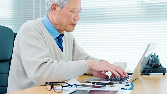 Senior businessman working in office.