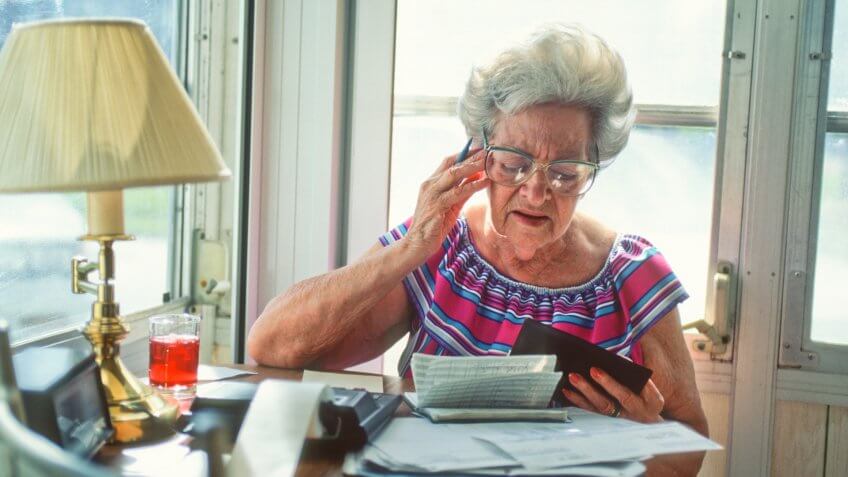 senior woman confused over finances.