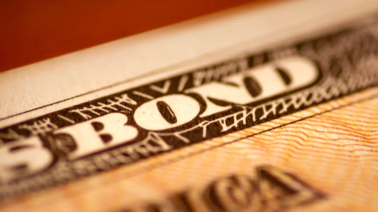 Close up picture of a United States savings bond, showing the lettering at the top of the paper bond.