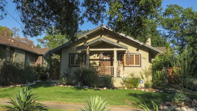 A small house in Pasadena, California with trees around it.