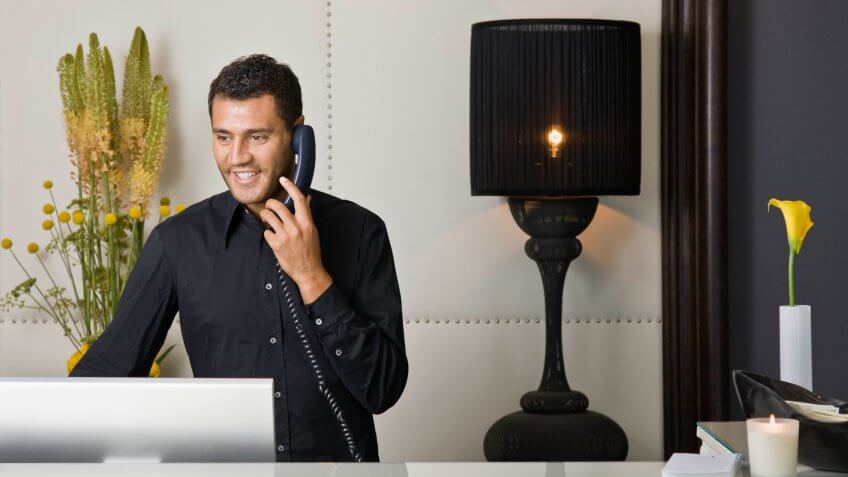 Male receptionist talking on the phone