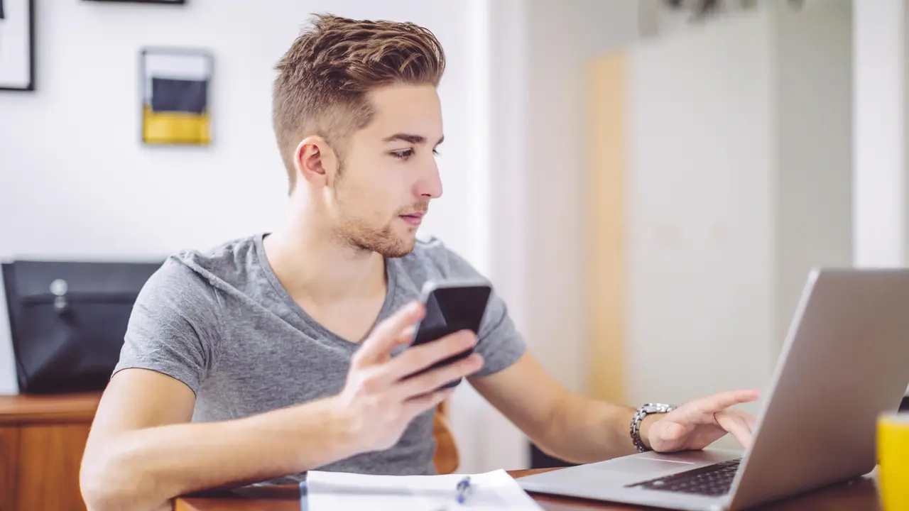 Young man working at home office.