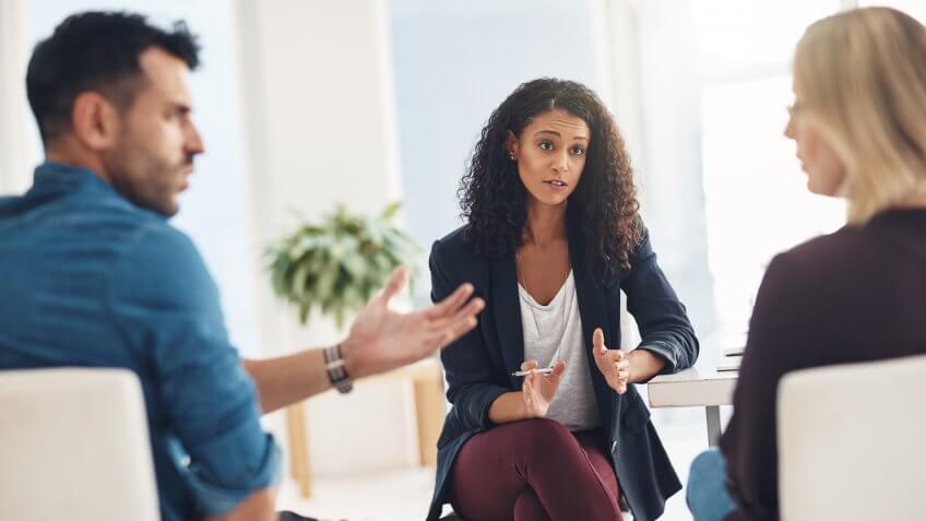 Shot of a couple having an argument during a counseling session with a therapist.