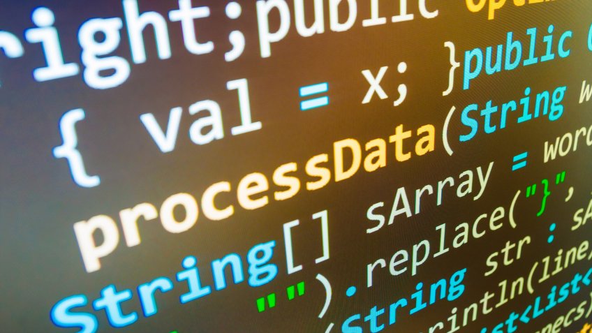 Software developer programming code on computer.