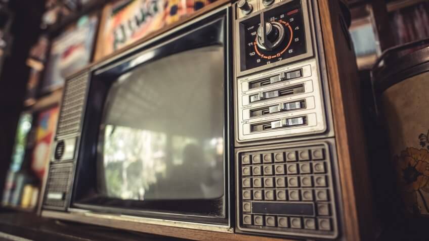 Antique grunge portable black and white television screen in vintage style.