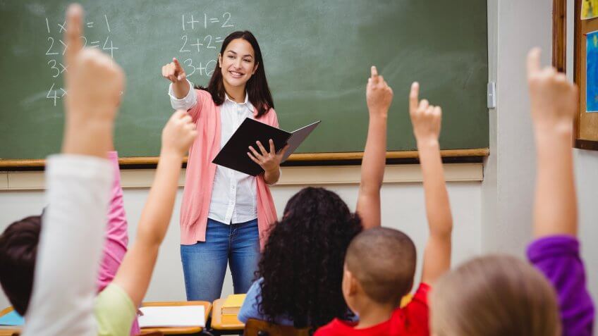 Teacher asking her students a question at the elementary school.