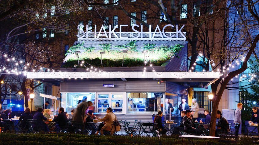 NEW YORK CITY - APRIL 15: Customers dine at Shake Shack in Madison Square Park April 15, 2013 in New York, NY.