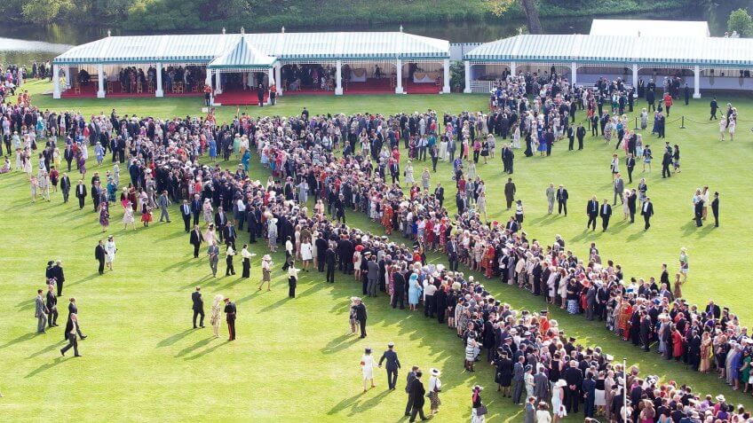 Guests Wait To Meet Britain's Queen Elizabeth Ii And Prince Philip As They Host The First Buckingham Palace Garden Party Of The Summer In London.