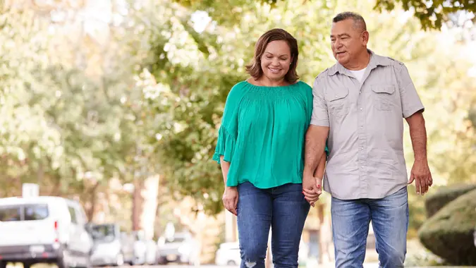retired couple walking i a nice neighborhood