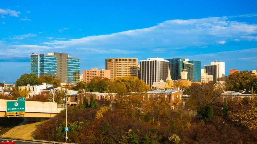 Downtown Wilmington Skyline during the late afternoon with a highway in the foreground.