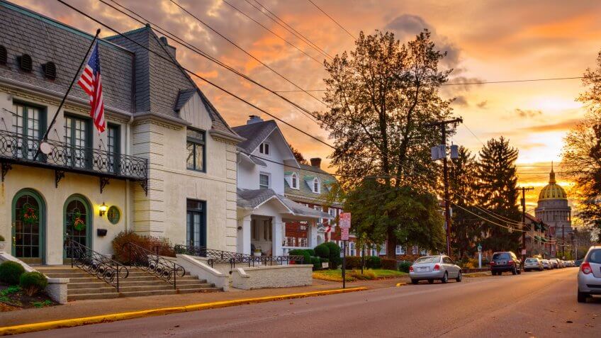Residential street in downtown Charleston, West Virginia with the Capitol building in the background at sunrise.