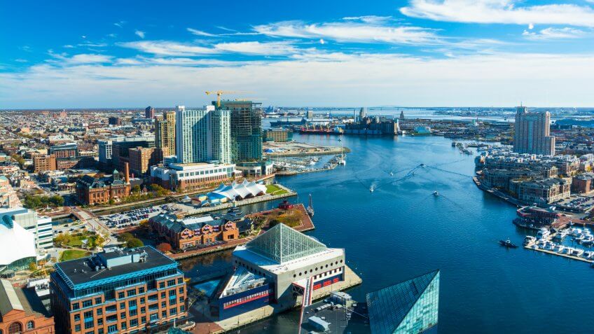 Aerial of Baltimore City with the Patapsco River and waterfront buildings.