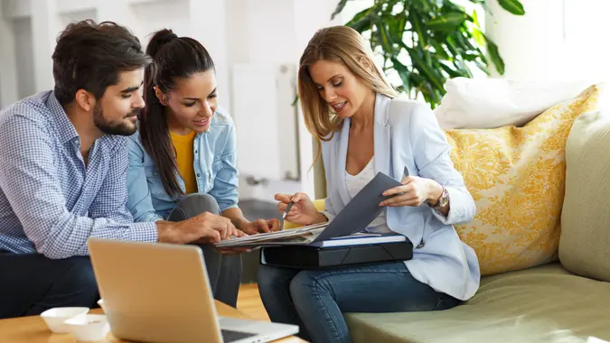 life insurance agent speaking with her clients about their policy
