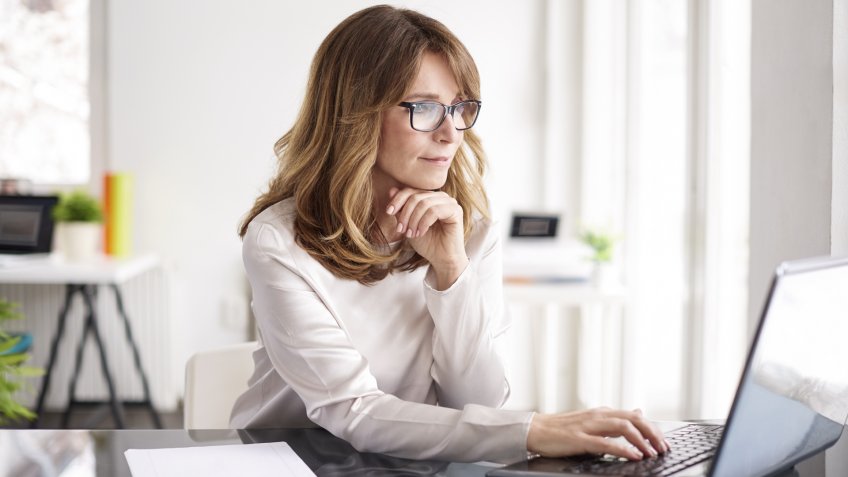 Shot of an attractive mature businesswoman working on laptop in her workstation.