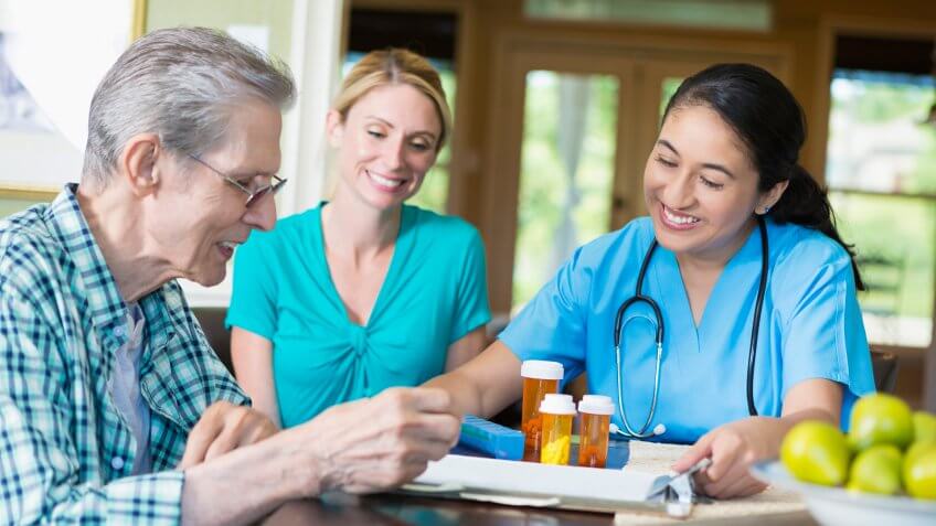 Senior male patient talks with home health care nurse.
