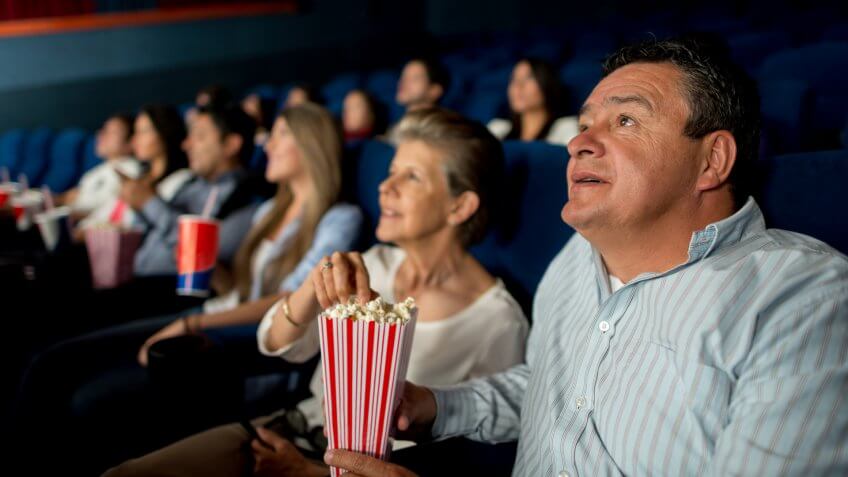 Senior couple at the cinema watching a movie.