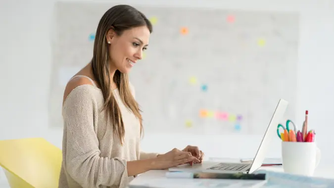 Successful business woman working online at the office on laptop computer.