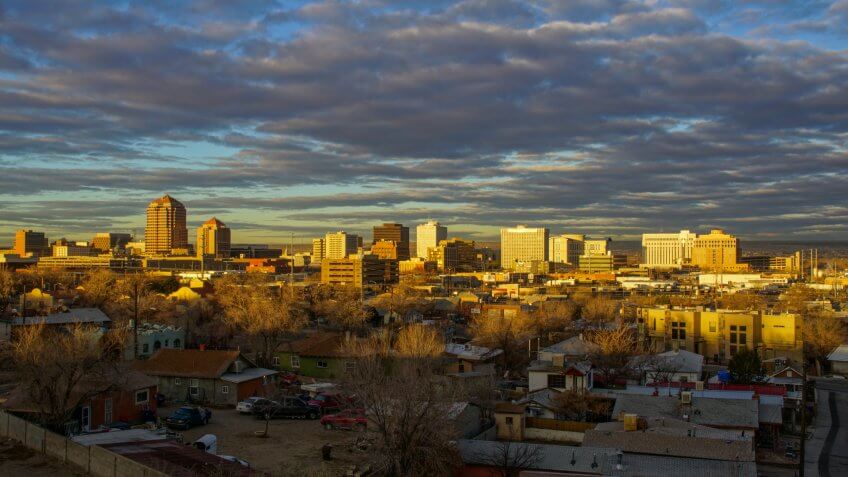 Albuquerque, New Mexico, USA - January 26, 2017: The downtown city skyline of Albuquerque, New Mexico early in the morning as the sun illuminates the buildings with a golden glow.